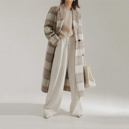Elegant plaid double-breasted long woollen coat for women, featuring a premium blend of wool, cotton and polyester for exceptional quality and warmth.