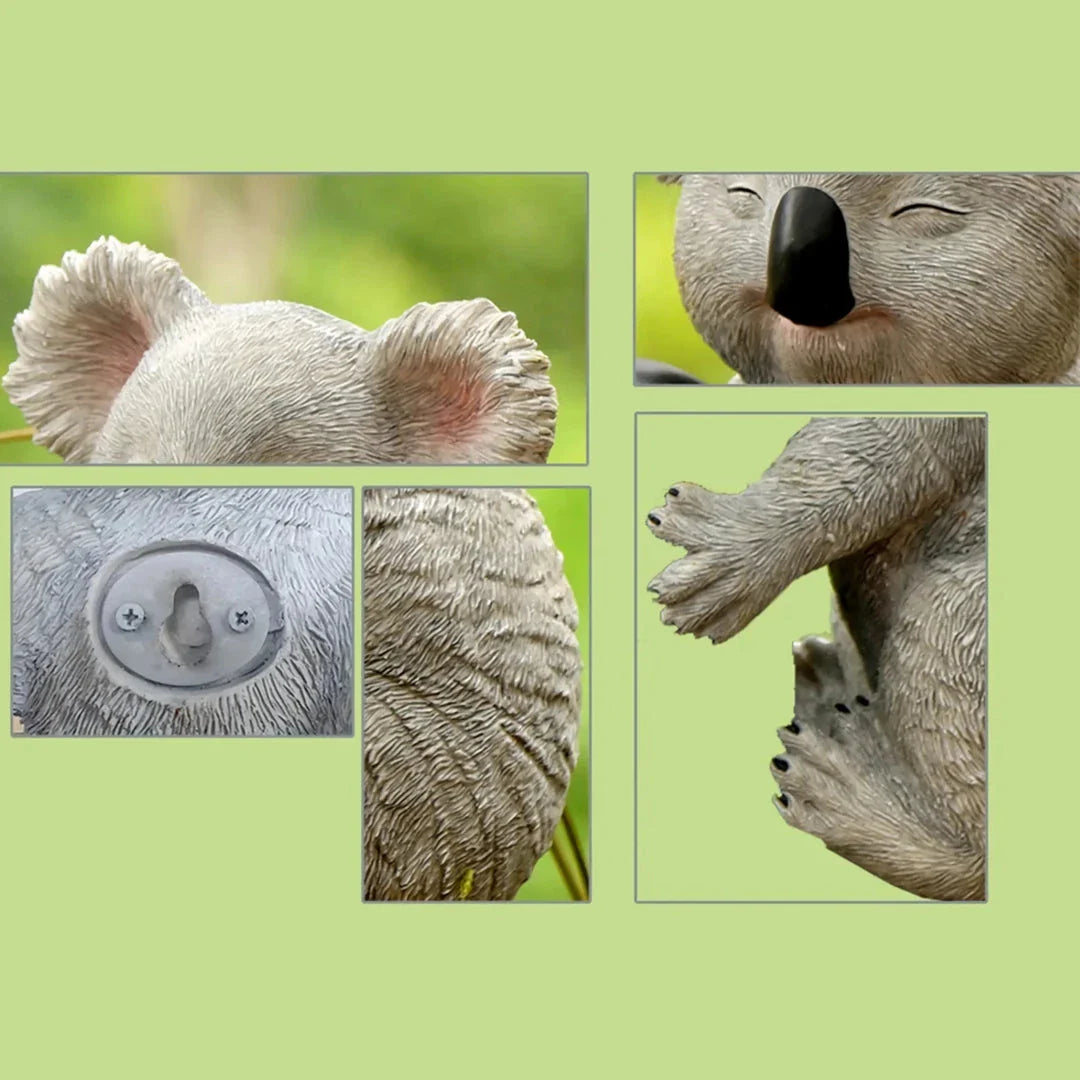 A lifelike grey resin koala statue climbing on a tree, adding a charming and whimsical touch to a garden or outdoor space