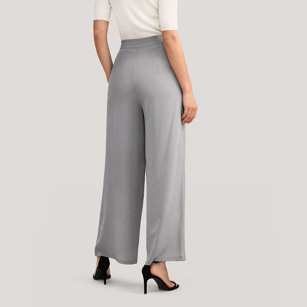 Chic silk wide-leg trousers in a sophisticated grey colour, featuring a high-waist design and relaxed fit for all-day comfort and style.
