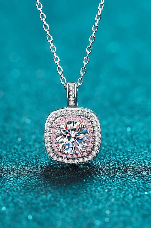 A rhodium-plated sterling silver necklace with a geometric pendant featuring a sparkling Moissanite gemstone over 0.3 carats.