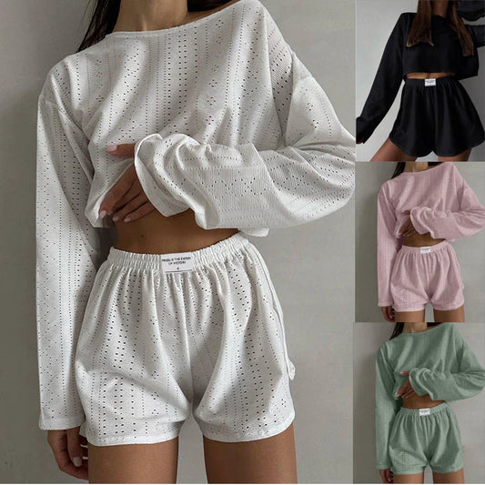 Elegant 2-piece women's suit with long-sleeved pullover top and tailored shorts in a minimalist design