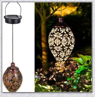 Decorative outdoor solar lanterns hanging in a lush garden, providing warm, ambient lighting