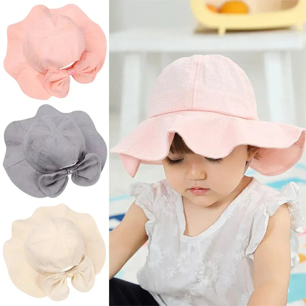 Adorable pink princess baby bucket hat with bow detail for sun protection and fashionable wear