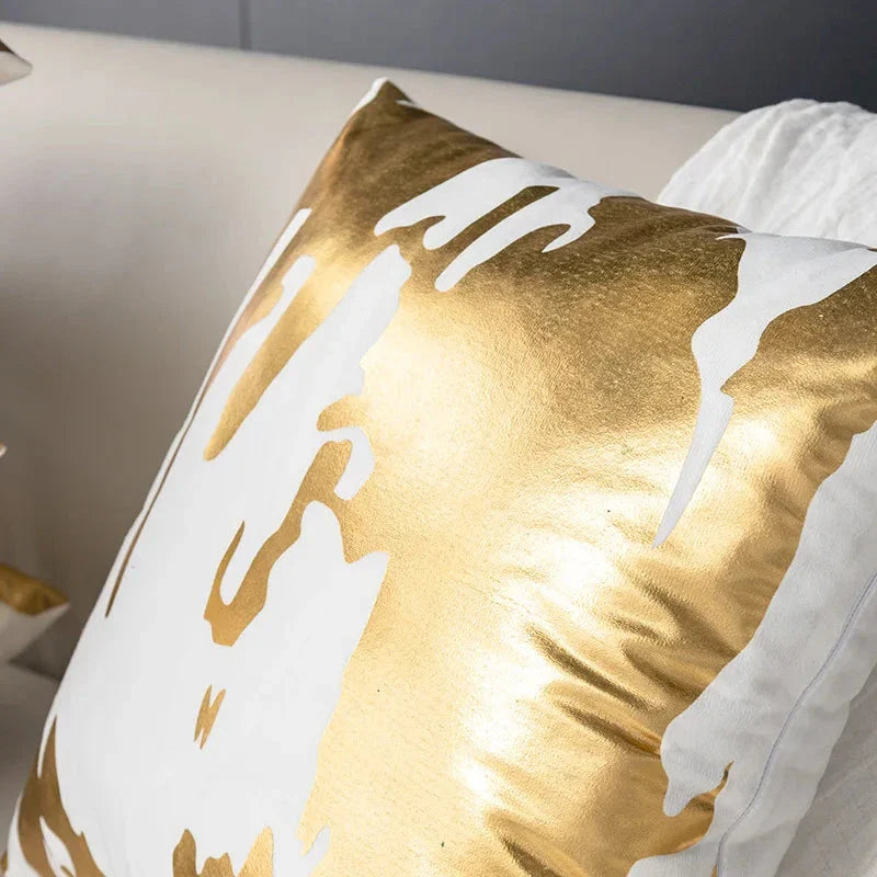 Pair of Nordic-inspired geometric plush pillowcases with a luxurious gold pattern on a white and black background