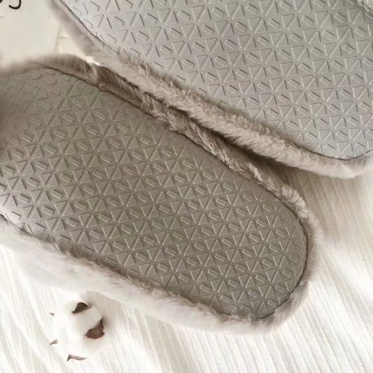 Pair of cosy, plush home slippers featuring a playful penguin design
