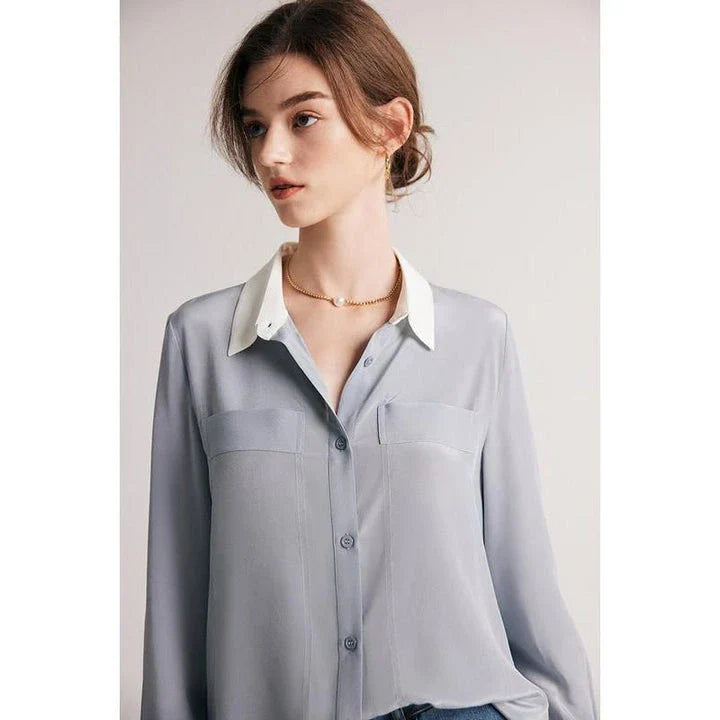 A chic and elegant silk crepe de chine blouse in a timeless solid pattern, perfect for professional and casual wear.