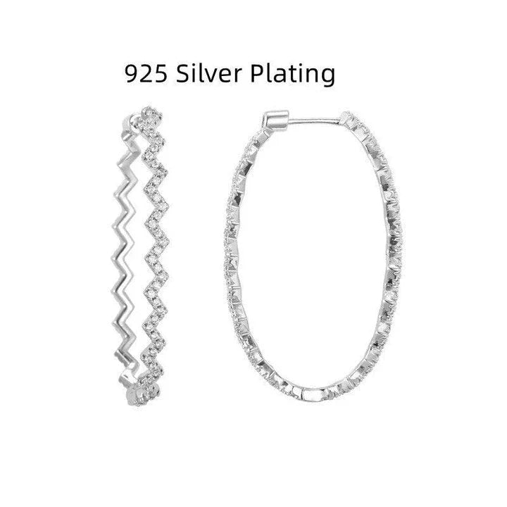 A pair of elegant sterling silver geometric earrings with a captivating wave-like pattern, inspired by the latest fashion trends in Japan and South Korea.