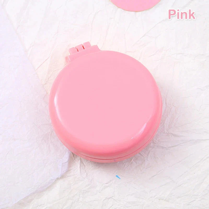 Portable folding hair comb with mirror, featuring a dual-sided design with a round mirror and eco-friendly hairbrush for on-the-go styling and grooming