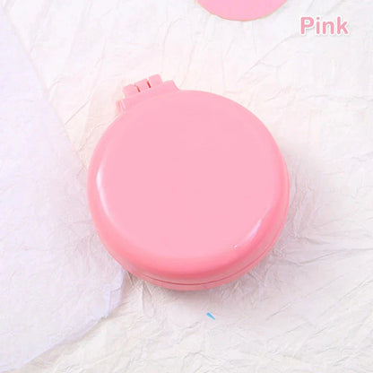 Portable folding hair comb with mirror, featuring a dual-sided design with a round mirror and eco-friendly hairbrush for on-the-go styling and grooming