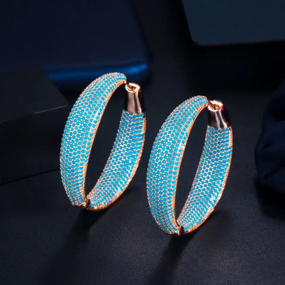 Pair of stunning blue gemstone drop earrings with a regal crown design, inlaid with shimmering zircon stones