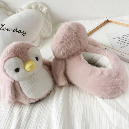 Pair of cosy, plush home slippers featuring a playful penguin design