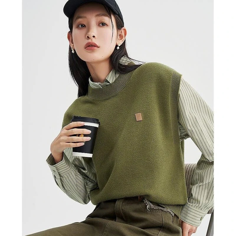 A cozy and chic knitted sleeveless vest in various colours, featuring a straight silhouette and a blend of premium materials for warmth and comfort.