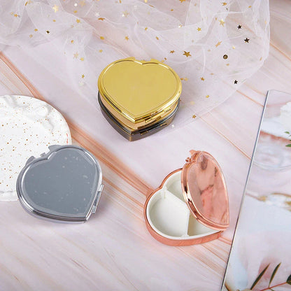 Heart-shaped metal pill box with built-in mirror for convenient storage and touch-ups on the go