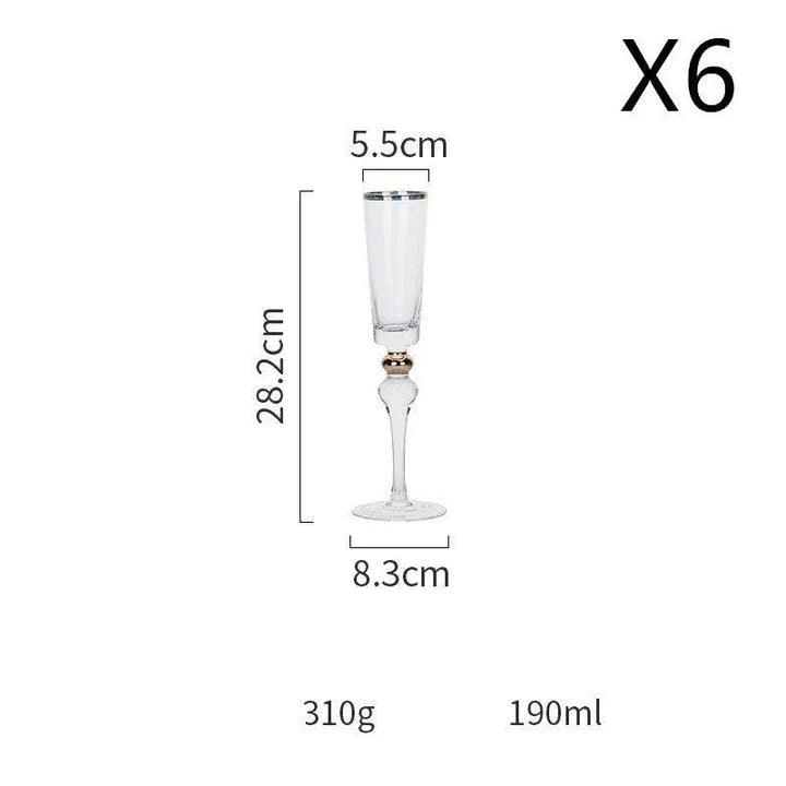 Elegant crystal wine glasses with refined gold vertical patterns, perfect for enjoying fine wines and champagne