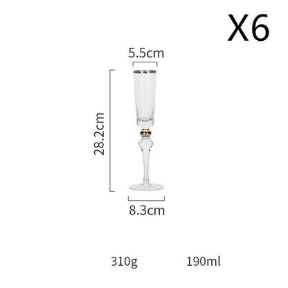Elegant crystal wine glasses with refined gold vertical patterns, perfect for enjoying fine wines and champagne