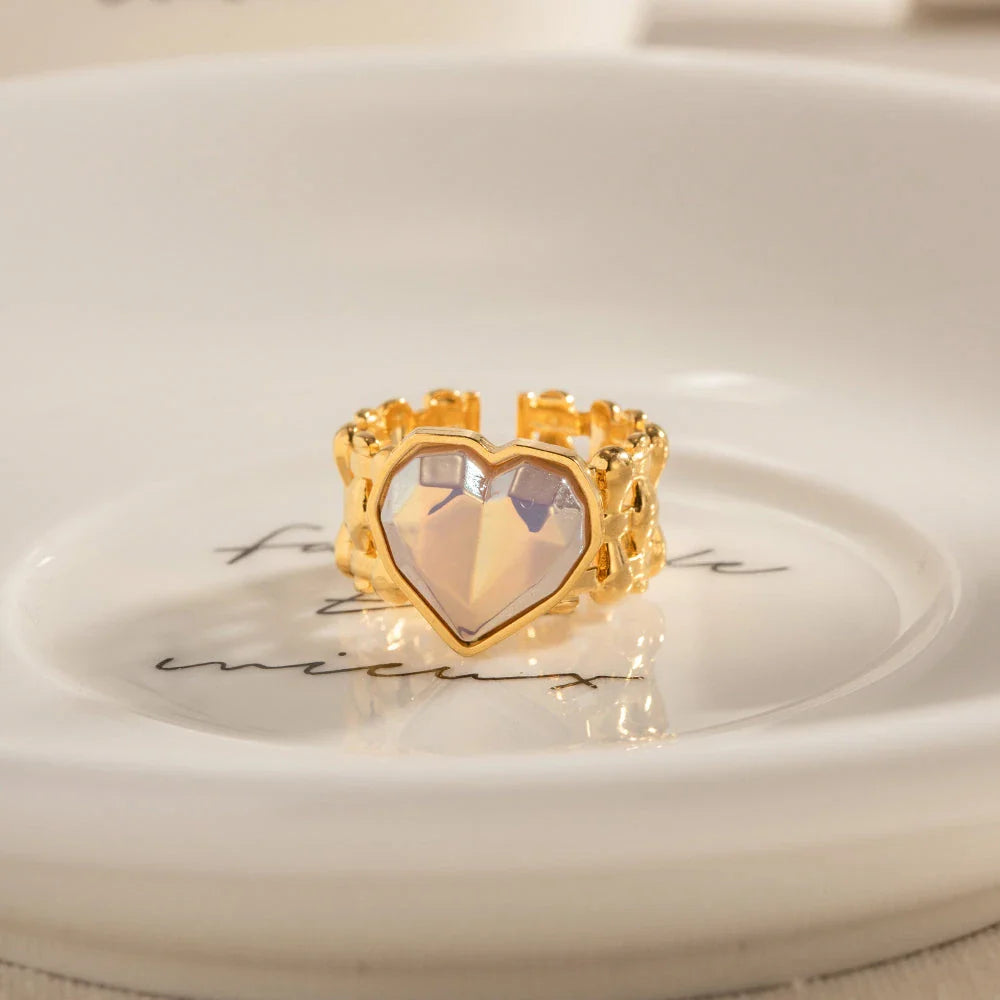 Adjustable stainless steel ring with a mermaid-inspired heart design and shell beads, a unique and versatile accessory.