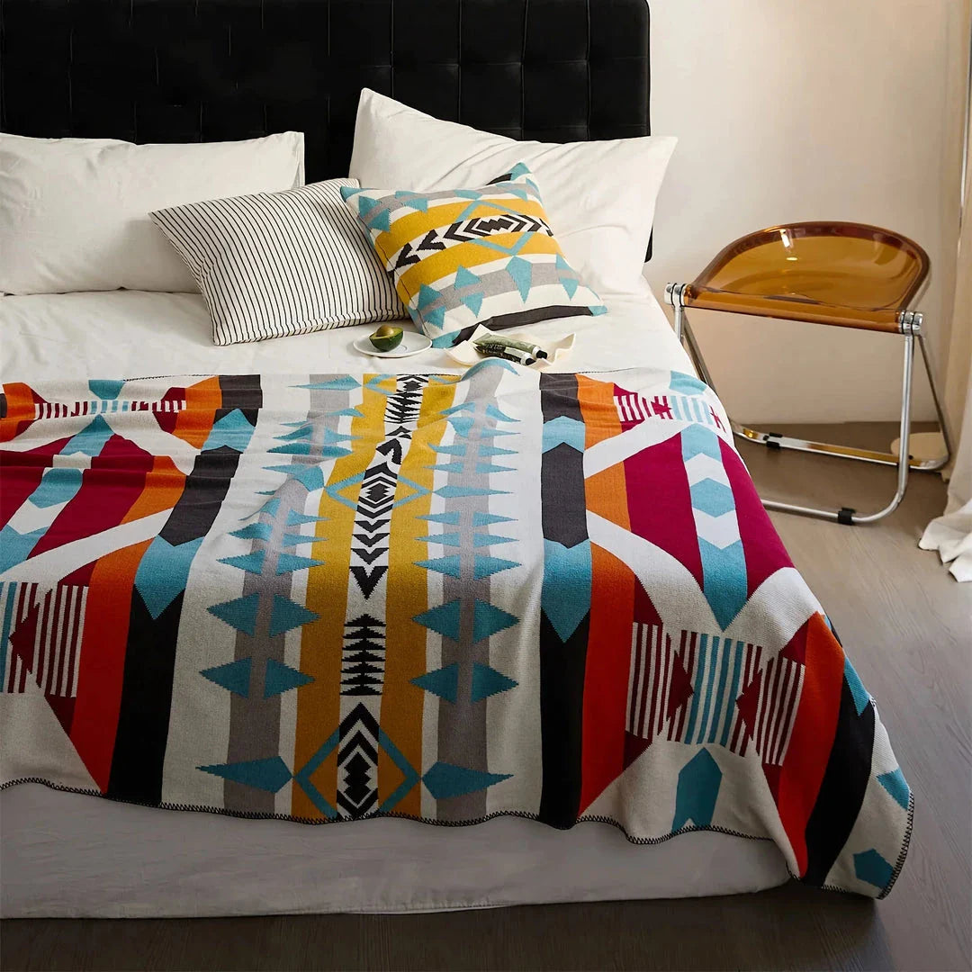 Cosy bohemian-style cotton blanket with vibrant geometric pattern, suitable for indoor and outdoor use