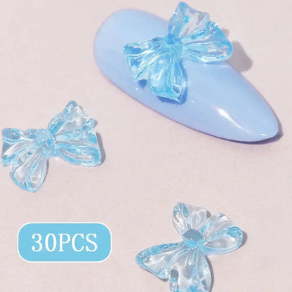 Charming candy-coloured bow nail charms in various colours, perfect for adding a playful touch to your manicure