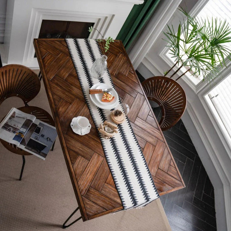 Elegant black and white cotton table runner with classic striped pattern and tassels, perfect for sophisticated dining decor