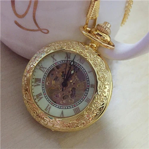 Elegant mechanical pocket watch with a golden pattern, showcasing British craftsmanship and timeless style.