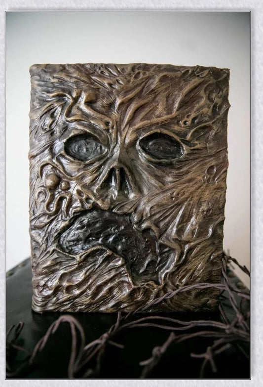 A haunting Necronomicon book with an embossed monster cover, aged pages, and a leathery, deathly texture