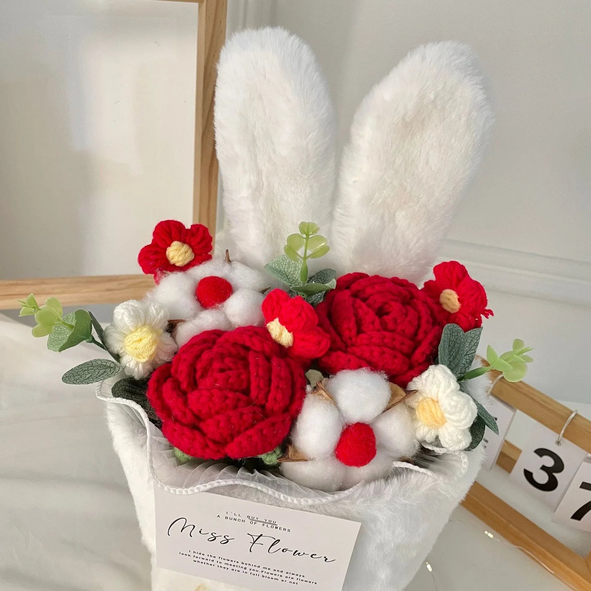 A delightful knitted rabbit bouquet doll in vibrant colours, featuring soft plush materials and a charming design