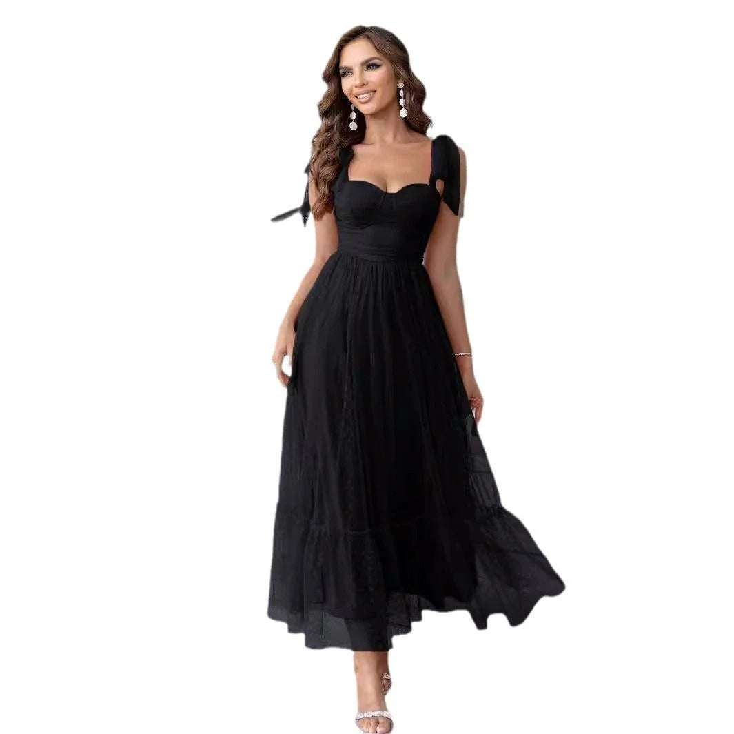 Enchanting fairy-style dress with flowing silhouette, delicate lace accents, and mid-length skirt in a classic black colour
