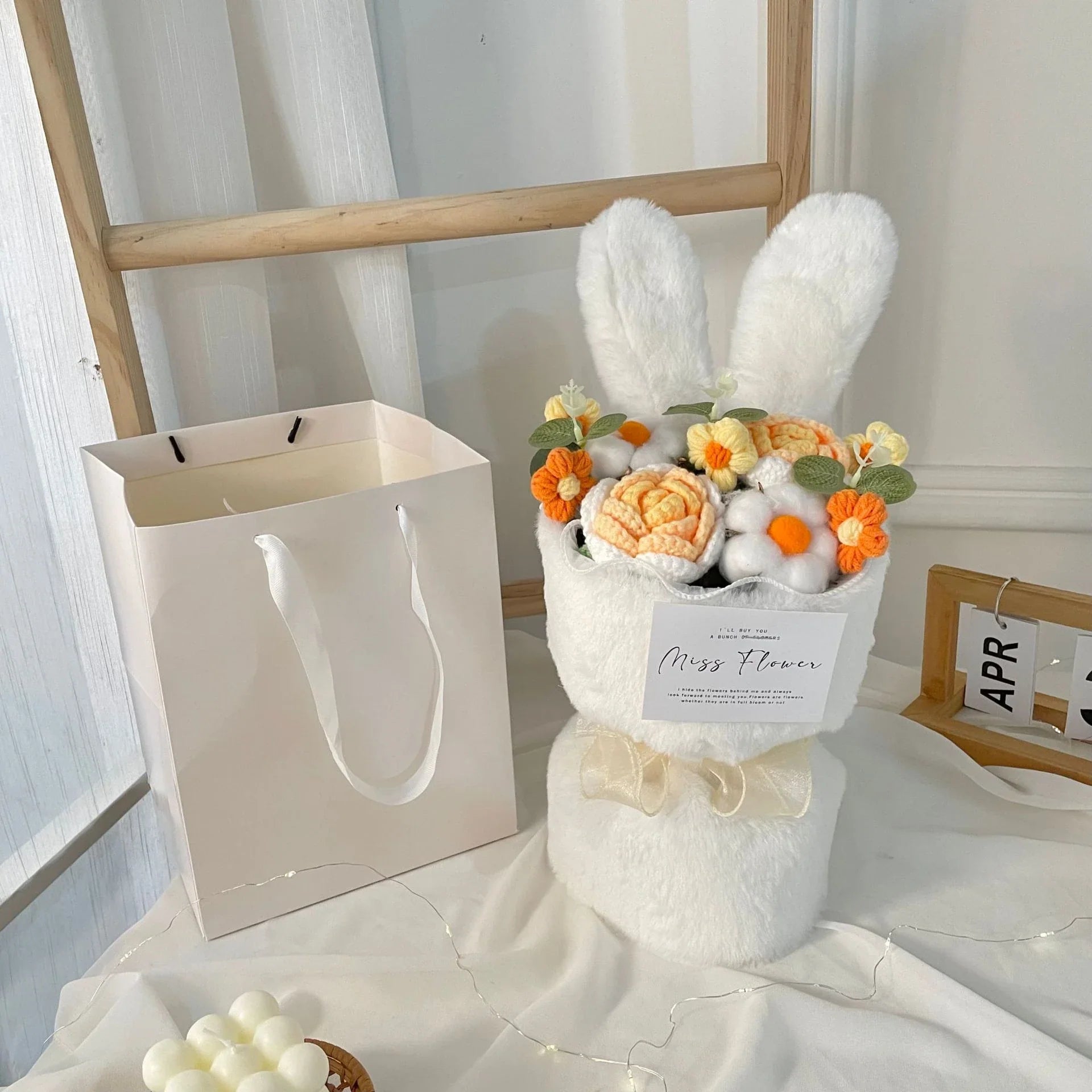 A delightful knitted rabbit bouquet doll in vibrant colours, featuring soft plush materials and a charming design