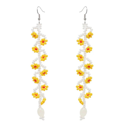 Elegant bohemian resin long tassel drop earrings in a vibrant yellow colour, featuring a mesmerising floral pattern and graceful movement