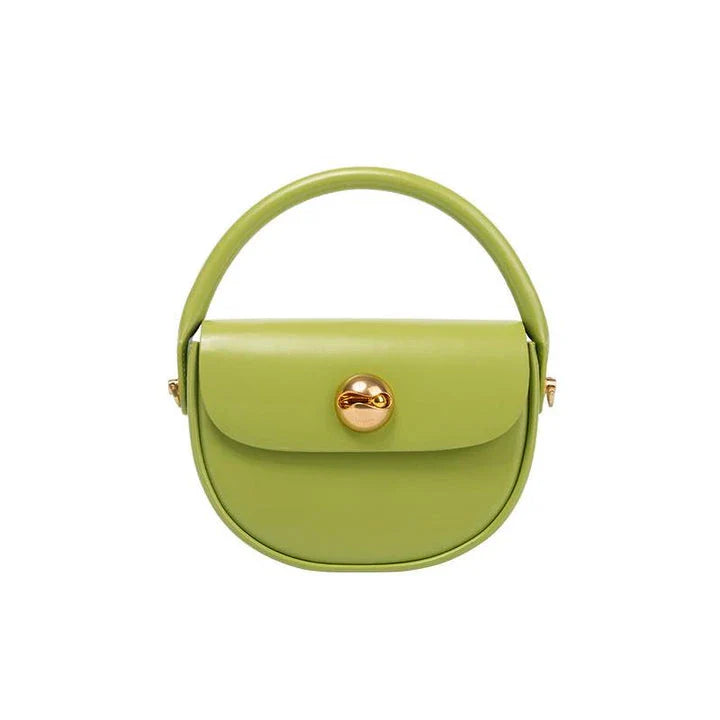 Exquisite red leather round handbag with ball-inlaid hardware, a chic and versatile accessory for UK fashion enthusiasts