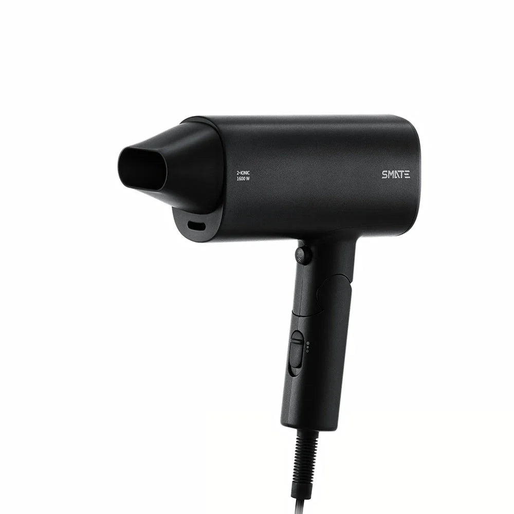 Compact and portable hair dryer with foldable handle, two-speed settings, and multiple nozzle positions for versatile styling