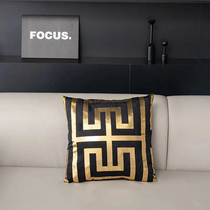 Pair of Nordic-inspired geometric plush pillowcases with a luxurious gold pattern on a white and black background