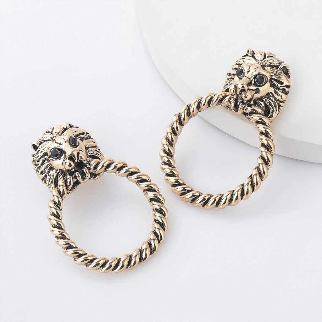 Close-up of the magnificent lion head stud earrings with a twisted hoop design, exuding power and confidence.