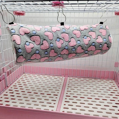 Cosy plush tunnel in grey for small pets like hamsters and guinea pigs, providing a comfortable and secure hideaway
