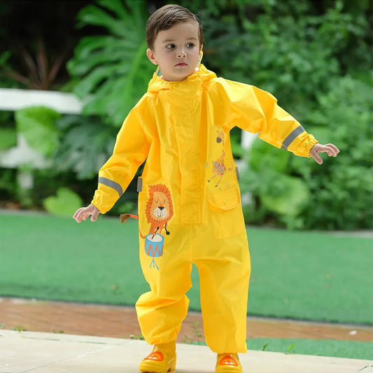 Children wearing a vibrant, dinosaur-themed waterproof rain jumpsuit playing outdoors in the rain