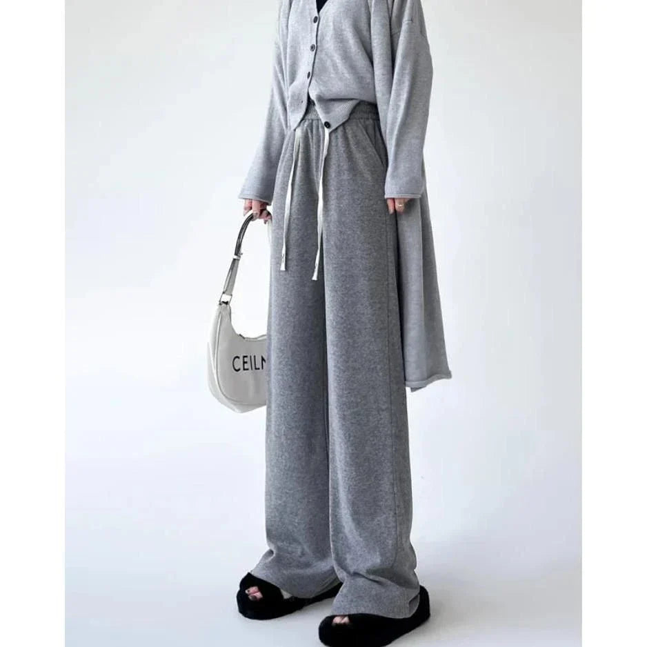 Elegant high-waist drawstring trousers in black, featuring a wide-leg cut and stylish lace-up pockets