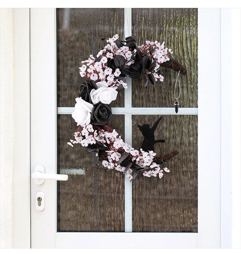 Spooktacular Halloween garland featuring a blend of dried white flowers, black roses, and mystical moon cat ornaments