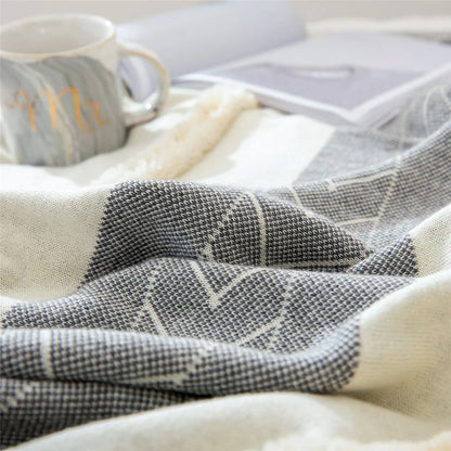 Cosy cotton tufted throw blanket with a geometric pattern and tassels in a soft yellow colour