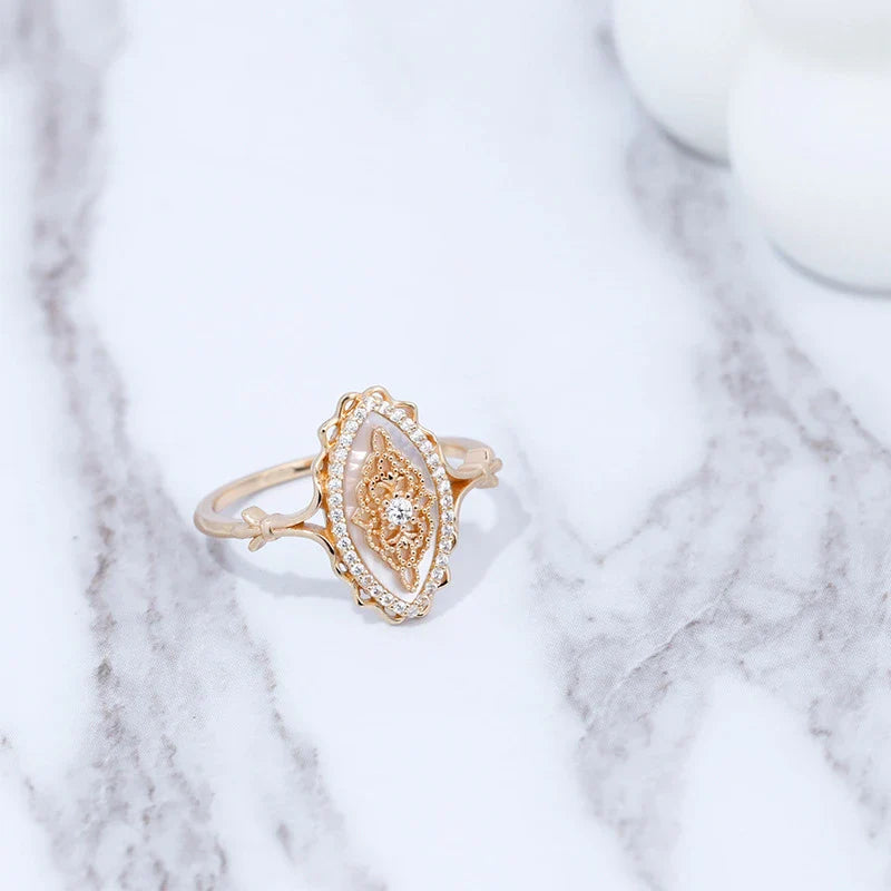 Elegant vintage-style natural white shell ring with silver construction, available in sizes 5 to 8