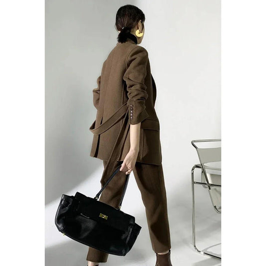 Elegant wool pant suits for women featuring a high-waist design, raglan sleeves, and modern 'hip hop' style trousers in a solid black colour