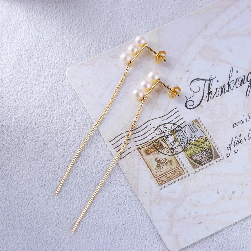 Elegant natural pearl earrings in a sleek silver frame, a timeless accessory for any occasion