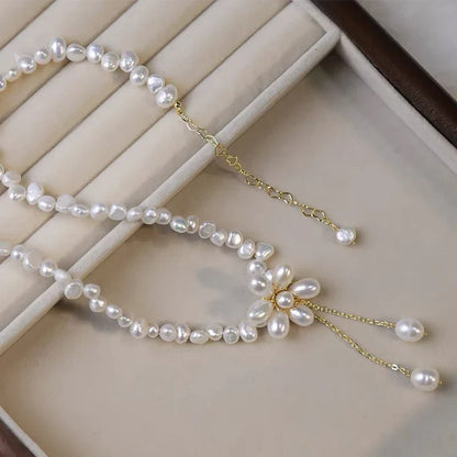 Elegant freshwater pearl necklace with intricate butterfly, dragonfly, and insect-inspired design on a copper-plated 14K gold chain
