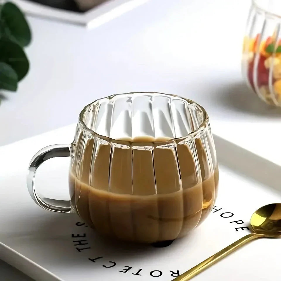 A set of heat-resistant glass mugs featuring a charming pumpkin pattern design, perfect for cosy UK mornings.