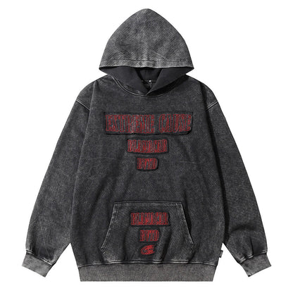 A premium cotton pullover hoodie with an embroidered letter patch in a variety of classic autumn colours