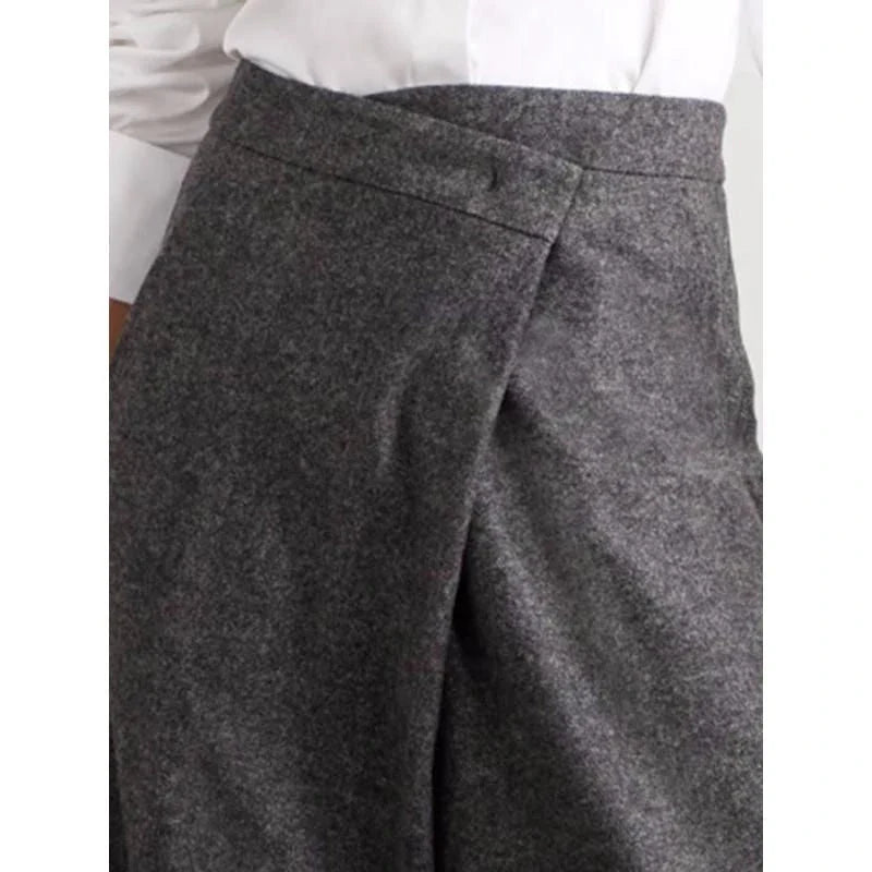 Elegant woollen wide-leg trousers in a high-waist design with unique asymmetric detailing, perfect for the discerning British woman.
