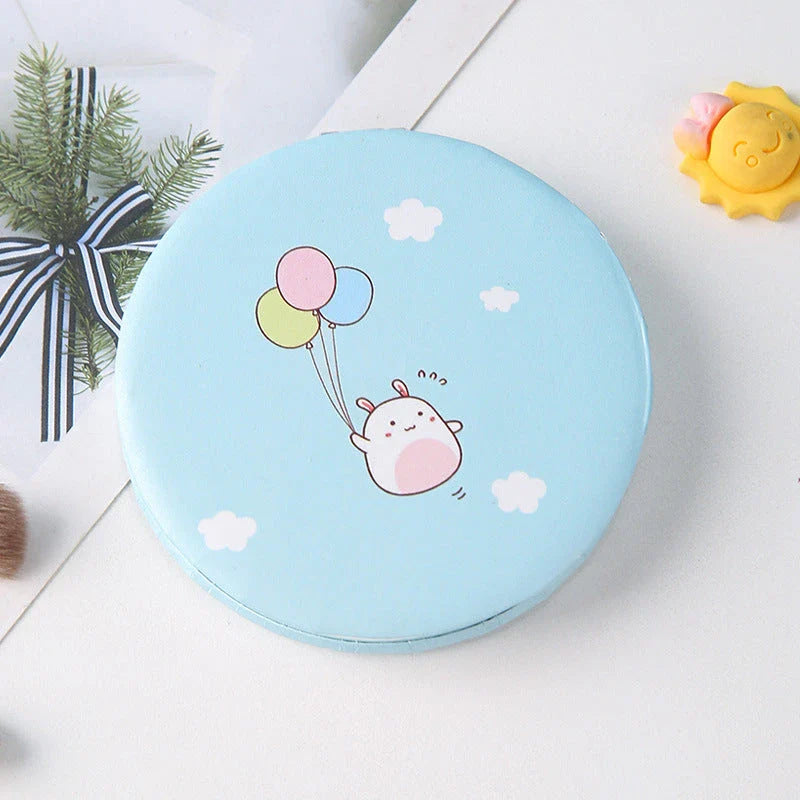 Compact portable foldable makeup mirror with cute cartoon prints for on-the-go beauty touch-ups