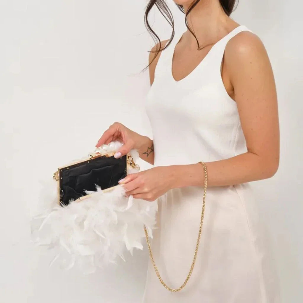 Elegant feather clutch bag with pearls and metal chains, a versatile and sophisticated evening accessory