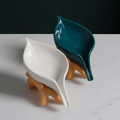 Elegant ceramic leaf-shaped soap holder with a sturdy base, adding a touch of nature-inspired sophistication to any bathroom