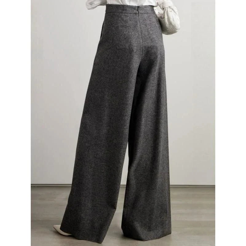 Elegant woollen wide-leg trousers in a high-waist design with unique asymmetric detailing, perfect for the discerning British woman.