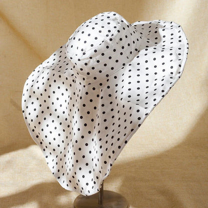Elegant oversized polka dot sun hat for stylish UK women, offering excellent sun protection and a classic, fashionable design.